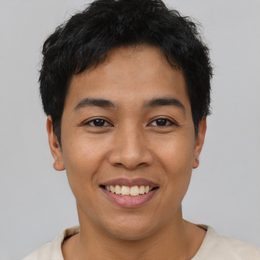 Joyful asian young-adult male with short  black hair and brown eyes