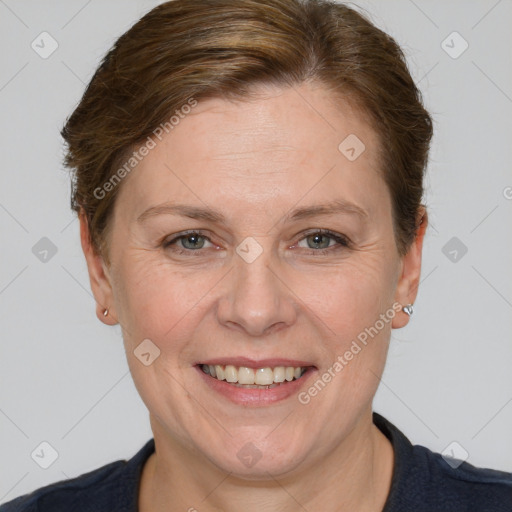 Joyful white adult female with short  brown hair and grey eyes