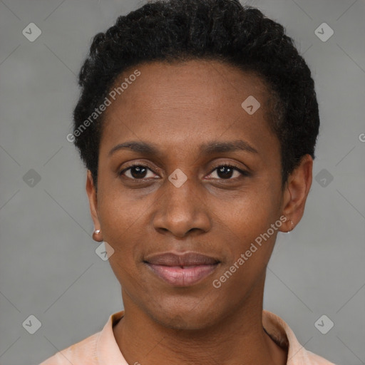 Joyful black young-adult female with short  black hair and brown eyes