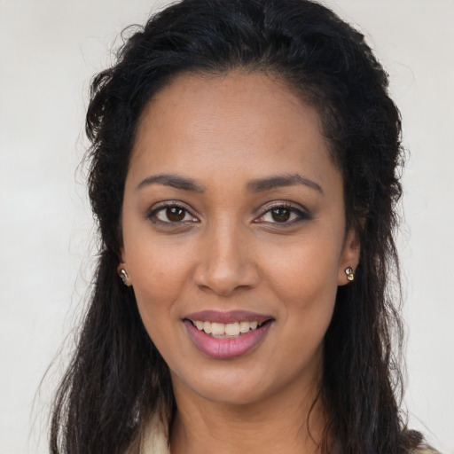 Joyful latino young-adult female with long  brown hair and brown eyes