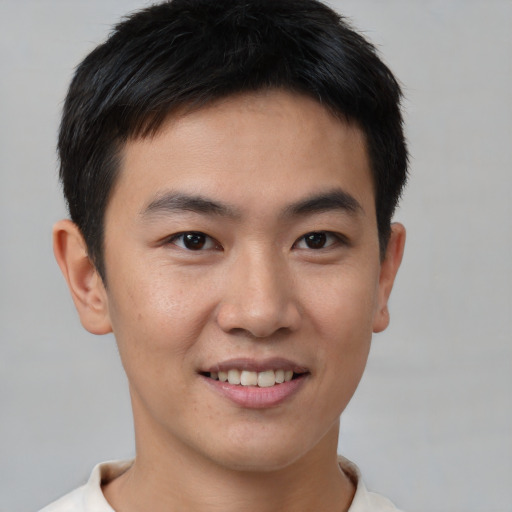 Joyful asian young-adult male with short  brown hair and brown eyes