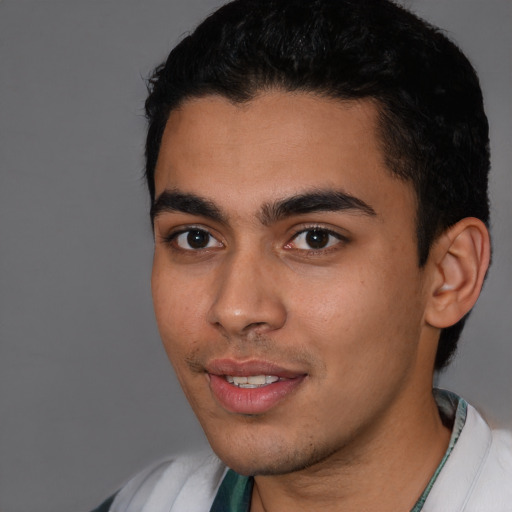 Joyful latino young-adult male with short  black hair and brown eyes