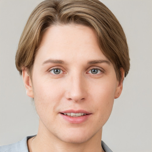 Joyful white young-adult female with short  brown hair and grey eyes