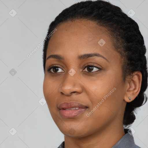 Joyful black young-adult female with short  black hair and brown eyes