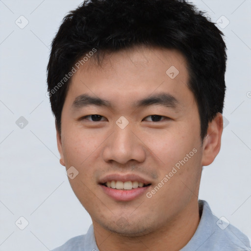 Joyful white young-adult male with short  black hair and brown eyes