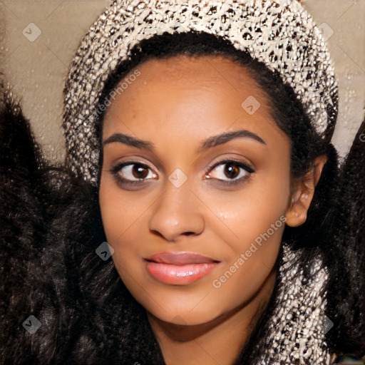 Joyful black young-adult female with long  black hair and brown eyes