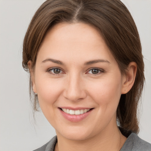 Joyful white young-adult female with medium  brown hair and brown eyes