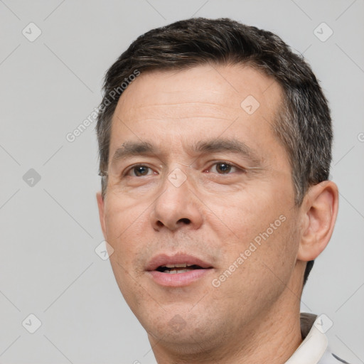 Joyful white adult male with short  brown hair and brown eyes