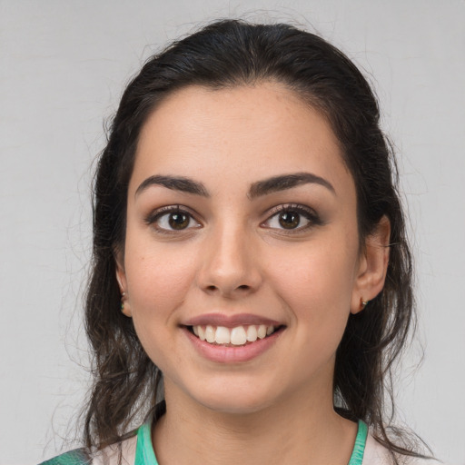 Joyful white young-adult female with medium  brown hair and green eyes