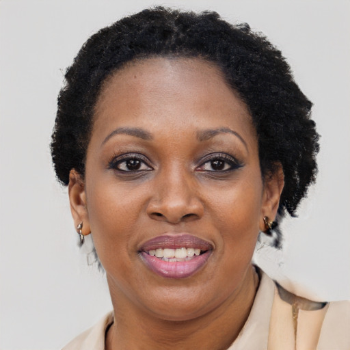 Joyful black adult female with short  brown hair and brown eyes
