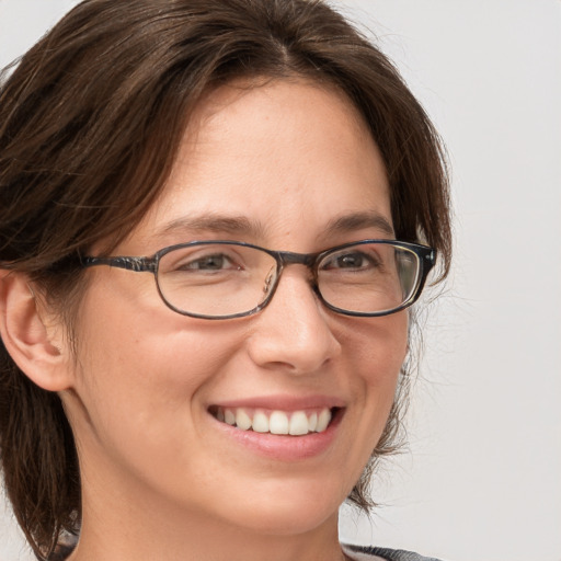 Joyful white adult female with medium  brown hair and grey eyes