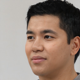 Joyful asian young-adult male with short  black hair and brown eyes