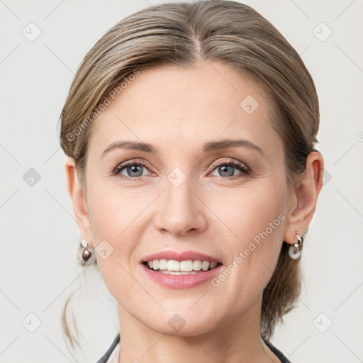 Joyful white young-adult female with medium  brown hair and grey eyes