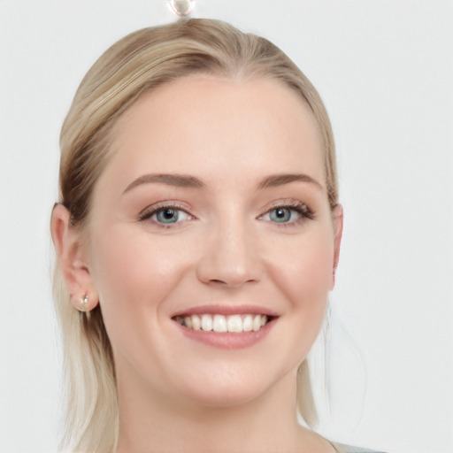 Joyful white young-adult female with long  brown hair and blue eyes