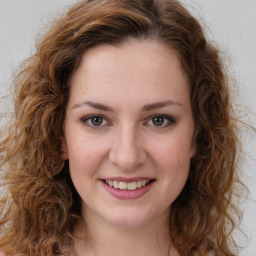 Joyful white young-adult female with long  brown hair and green eyes