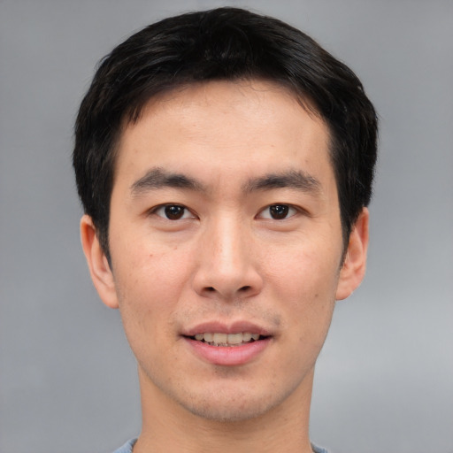 Joyful asian young-adult male with short  brown hair and brown eyes