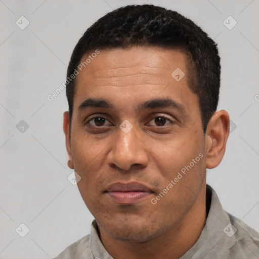 Joyful black adult male with short  black hair and brown eyes