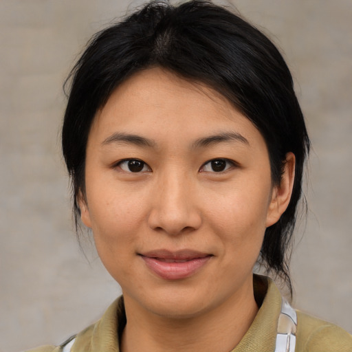 Joyful asian young-adult female with medium  brown hair and brown eyes