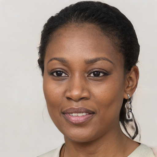 Joyful black young-adult female with medium  black hair and brown eyes
