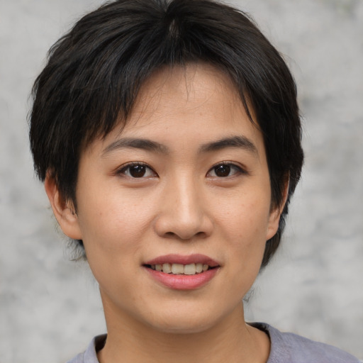 Joyful asian young-adult female with medium  brown hair and brown eyes