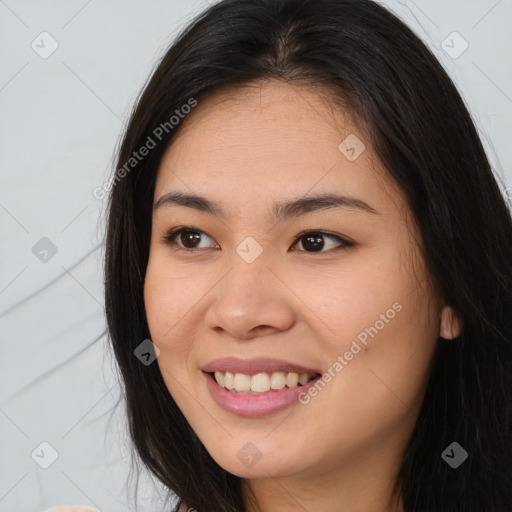 Joyful latino young-adult female with long  brown hair and brown eyes