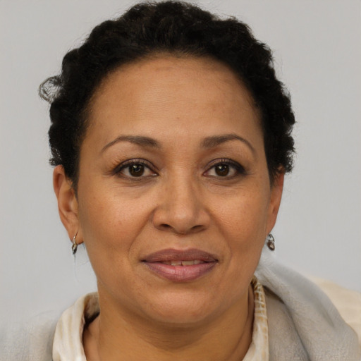 Joyful black adult female with short  brown hair and brown eyes