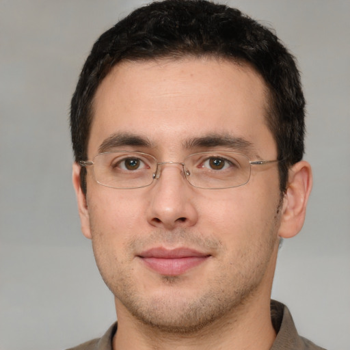 Joyful white young-adult male with short  brown hair and brown eyes