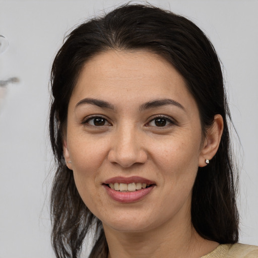 Joyful white adult female with medium  brown hair and brown eyes