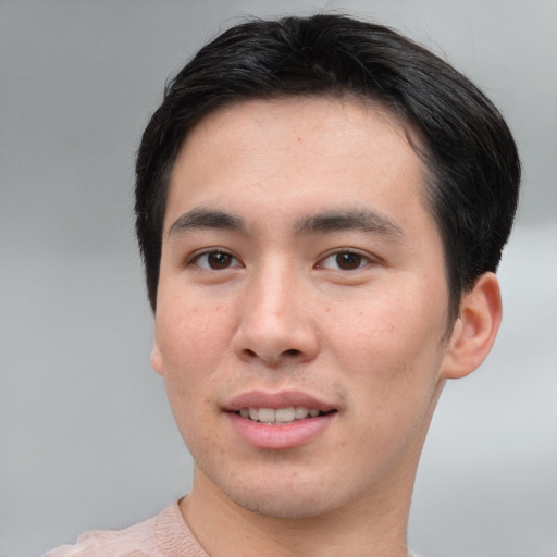 Joyful asian young-adult male with short  brown hair and brown eyes