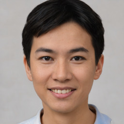 Joyful asian young-adult male with short  black hair and brown eyes