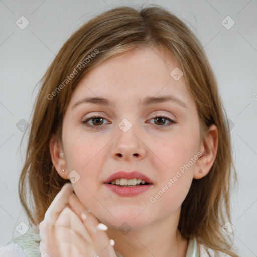 Joyful white child female with medium  brown hair and brown eyes