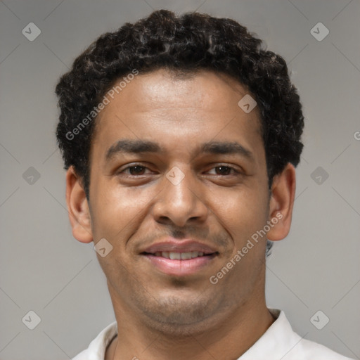 Joyful latino young-adult male with short  brown hair and brown eyes