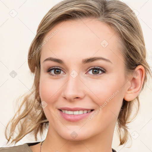 Joyful white young-adult female with medium  brown hair and blue eyes