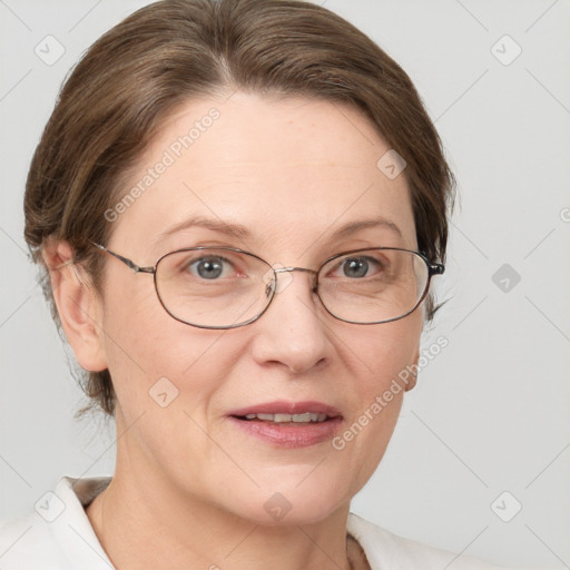 Joyful white adult female with medium  brown hair and grey eyes