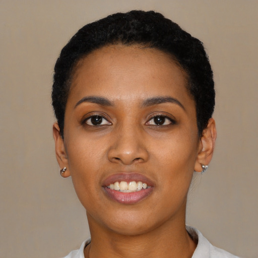Joyful black young-adult female with short  black hair and brown eyes