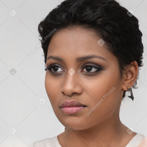 Joyful black young-adult female with short  brown hair and brown eyes