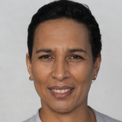 Joyful black adult female with short  black hair and brown eyes