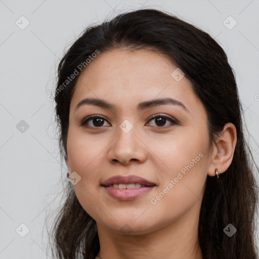 Joyful latino young-adult female with long  brown hair and brown eyes