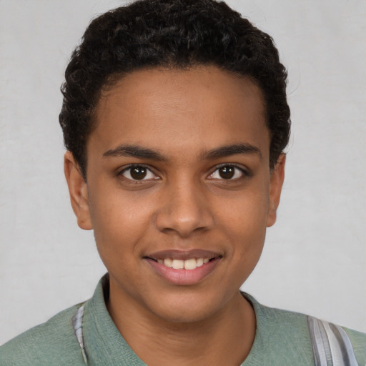 Joyful black young-adult male with short  brown hair and brown eyes