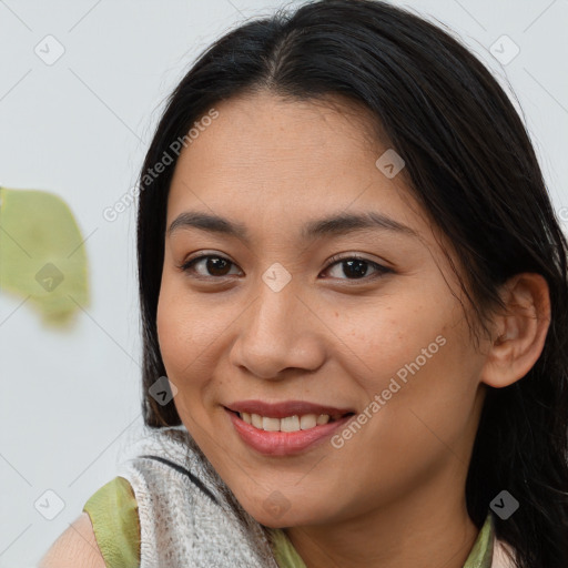 Joyful asian young-adult female with medium  brown hair and brown eyes