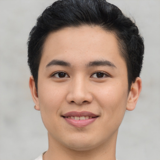 Joyful asian young-adult male with short  brown hair and brown eyes