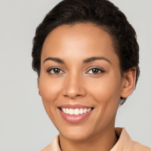 Joyful latino young-adult female with short  brown hair and brown eyes