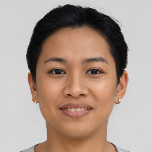 Joyful latino young-adult female with short  brown hair and brown eyes