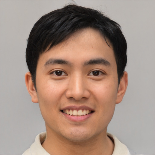 Joyful asian young-adult male with short  black hair and brown eyes