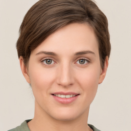 Joyful white young-adult female with short  brown hair and grey eyes