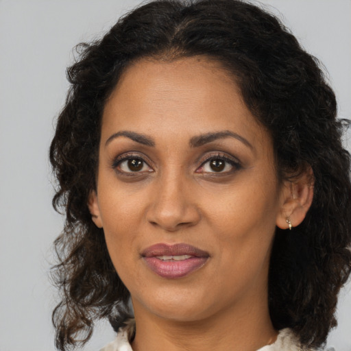 Joyful black young-adult female with medium  brown hair and brown eyes