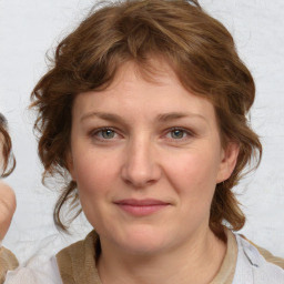 Joyful white young-adult female with medium  brown hair and blue eyes