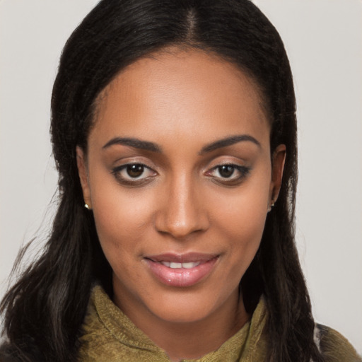 Joyful black young-adult female with long  brown hair and brown eyes