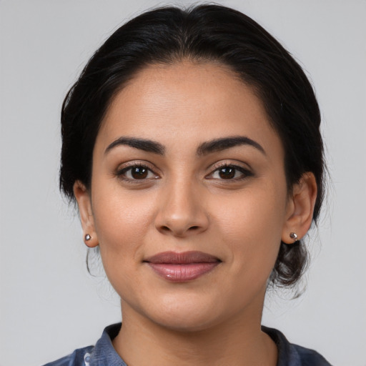 Joyful latino young-adult female with medium  black hair and brown eyes