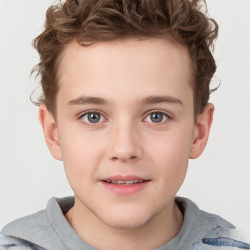 Joyful white child male with short  brown hair and grey eyes